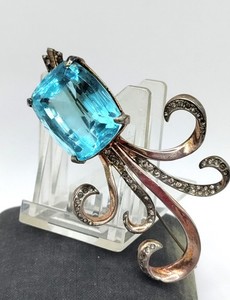 Sterling silver brooch with emerald-cut aquamarine and rhinestone swirls