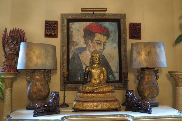 Gilt Buddha on a console with figural lamps in a Lincoln Park estate