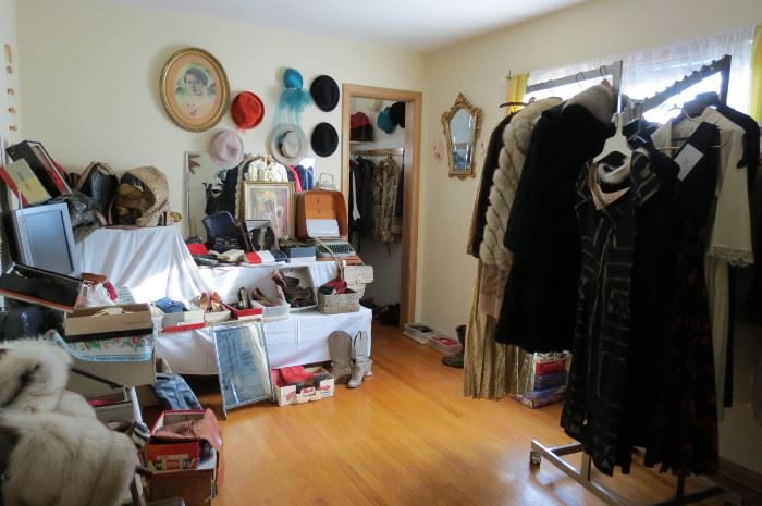 Room full of vintage clothing in the packed bungalow