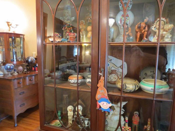 American Indian pottery and artisan pieces in curio cabinets