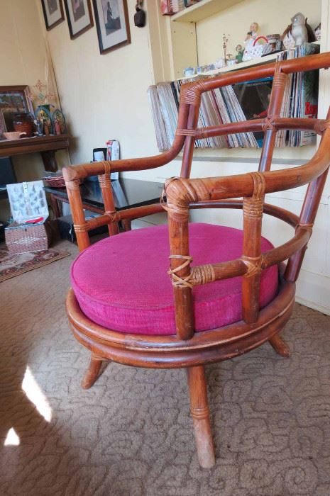 Rattan swivel chair with pink cushion from a Portage Park estate
