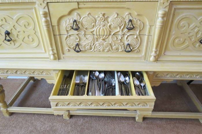 Flatware drawer open in the carved sideboard
